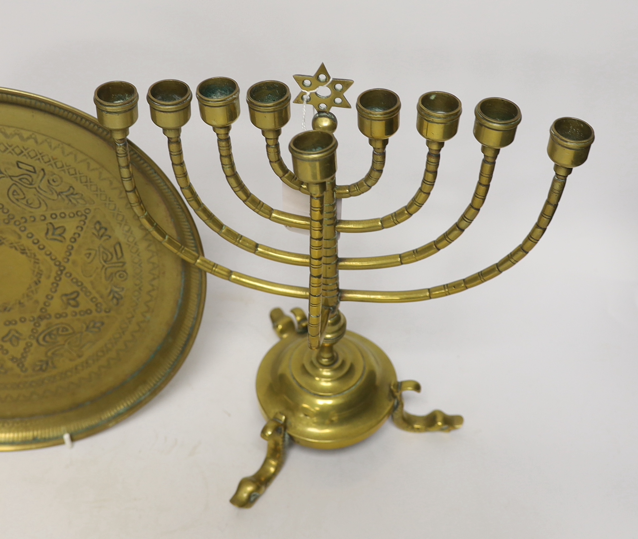 Two pieces of Judaica comprising brass Chanukka and circular dish, largest 31cm high